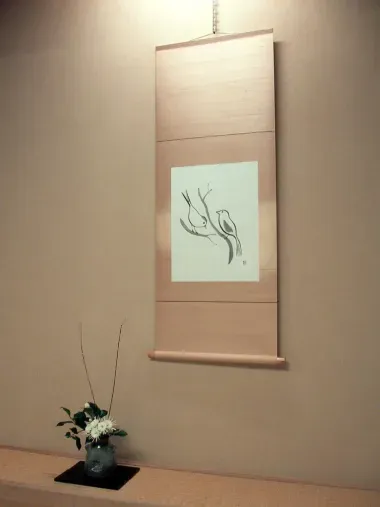 This takemonois composed of a flower arrangement and calligraphy suggesting spring